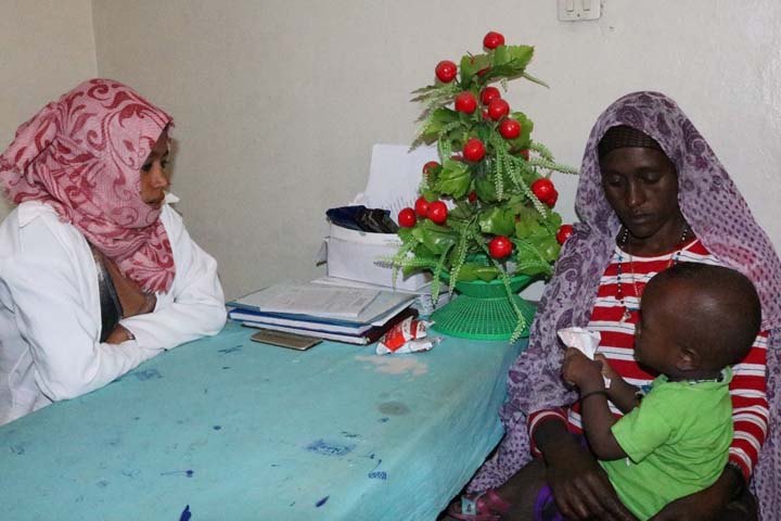 Halima and her baby with Zebiba, a midwife at the centre