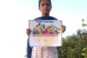 Kiroshini holding a picture of fruits and vegetables basket