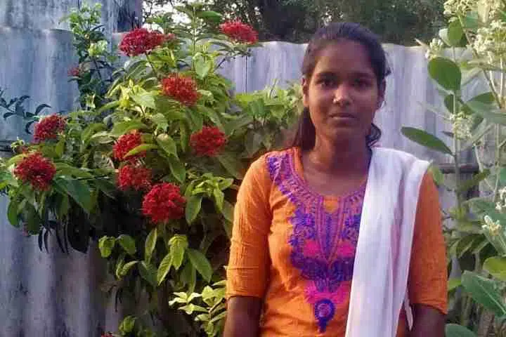 Suganya standing nearby plants