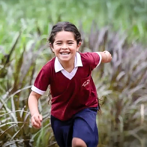 child running in long grass